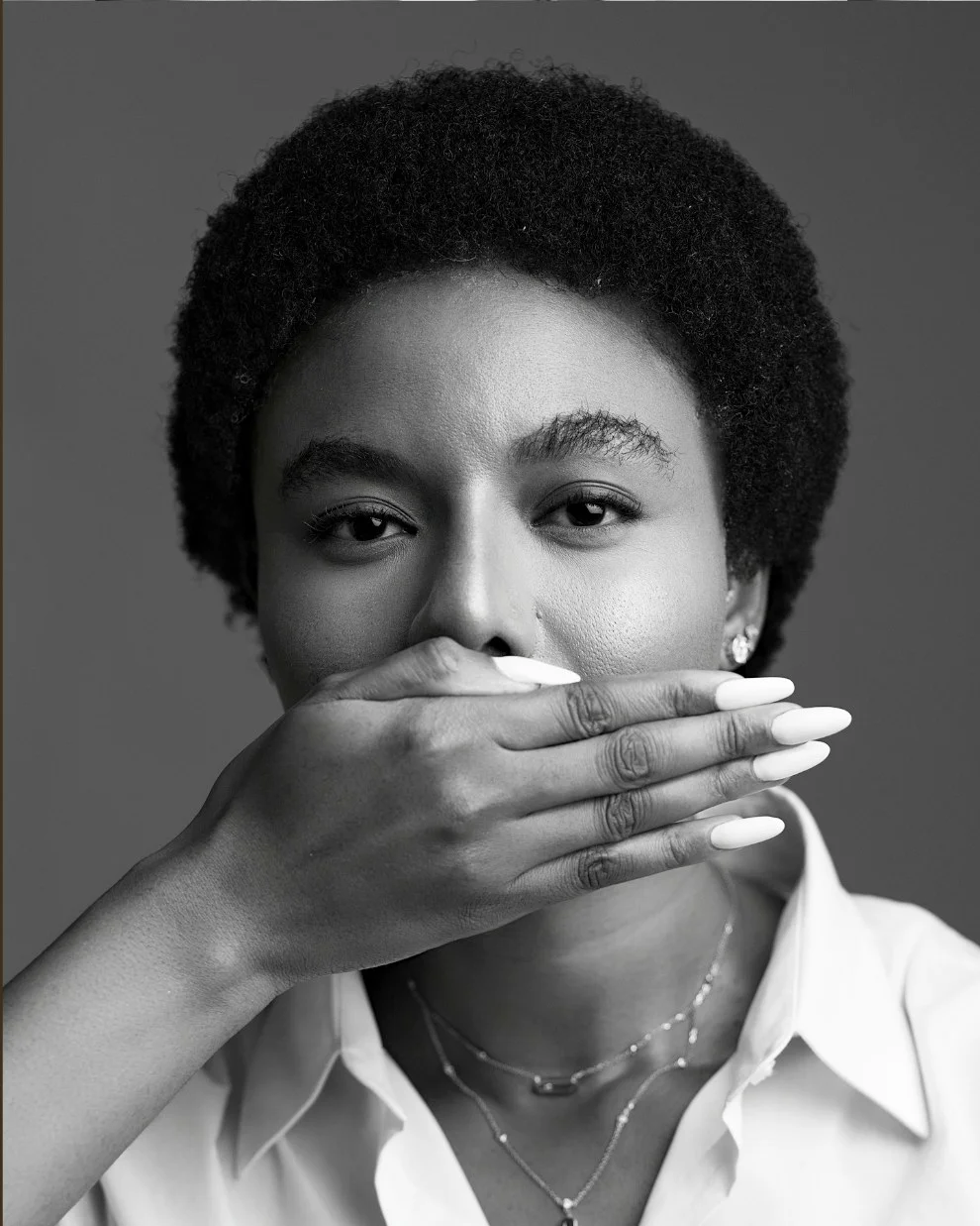 Nancy Isime covering her mouth in surprise