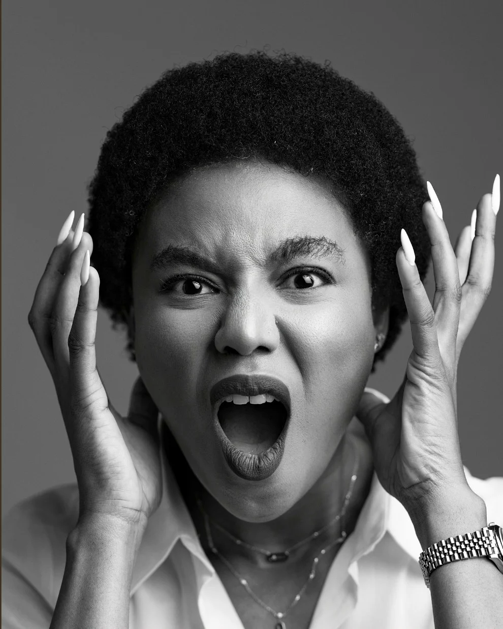 Nancy Isime, hands to her face in shock