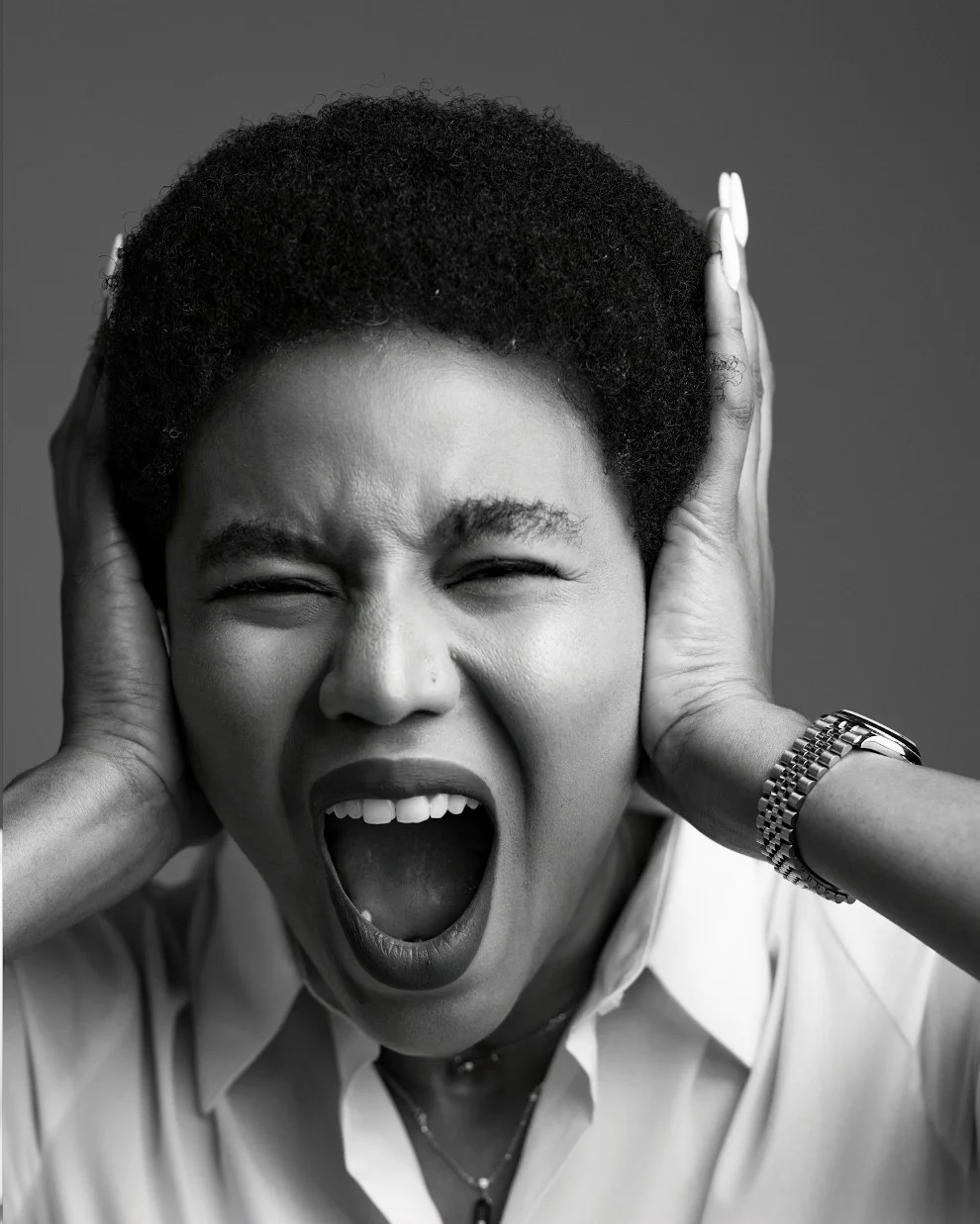 Nancy Isime winking and shouting, hands over her ears
